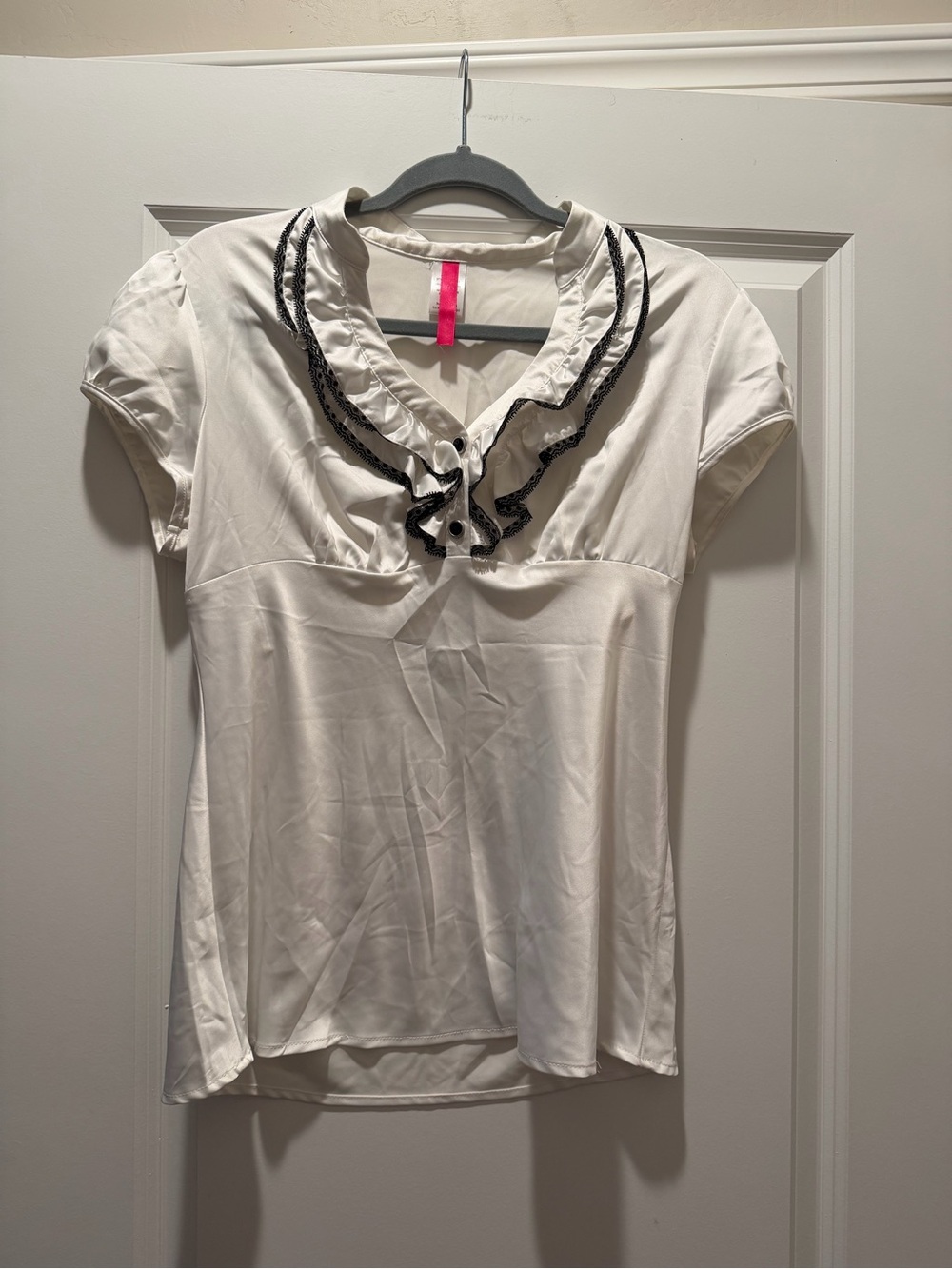 White Ruffled V-Neck Women’s Top with Black Trim